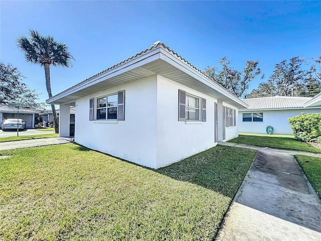 view of side of property with a lawn