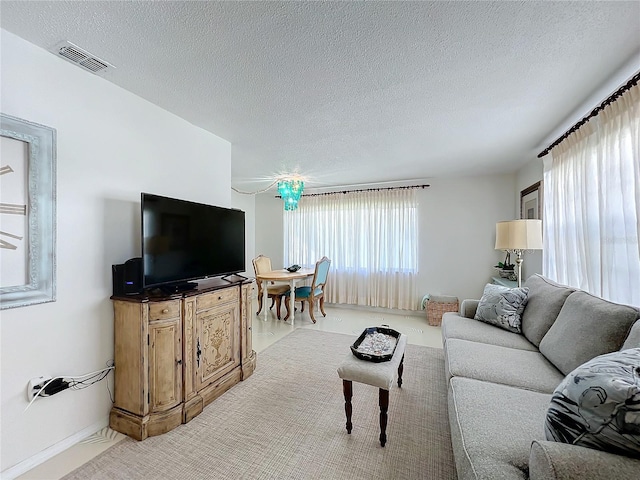 living room featuring carpet floors and a textured ceiling