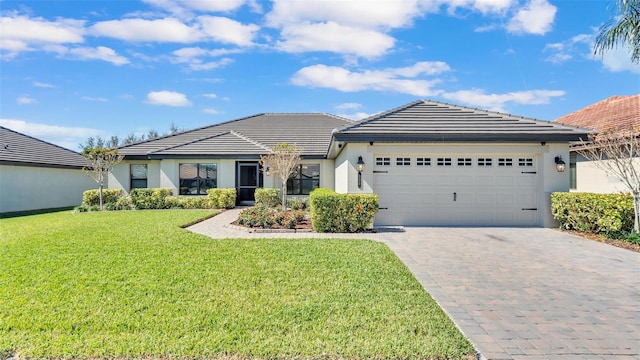 single story home with an attached garage, stucco siding, decorative driveway, and a front yard