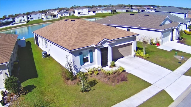 birds eye view of property with a water view and a residential view