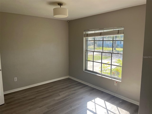 spare room with dark hardwood / wood-style flooring