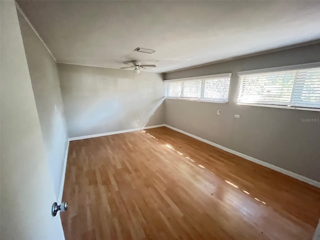 spare room featuring wood-type flooring and ceiling fan