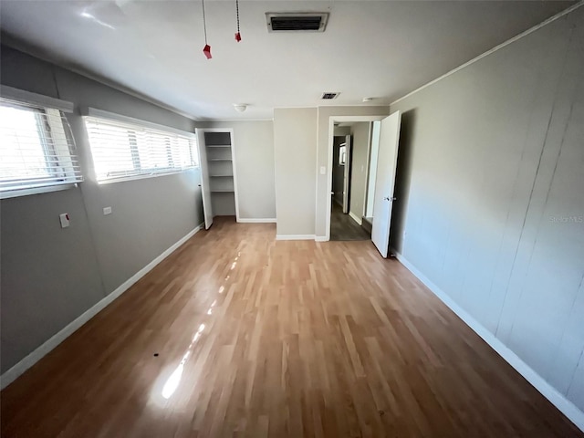 unfurnished bedroom featuring hardwood / wood-style flooring and a closet