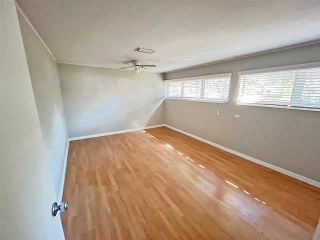 spare room with hardwood / wood-style floors and ceiling fan