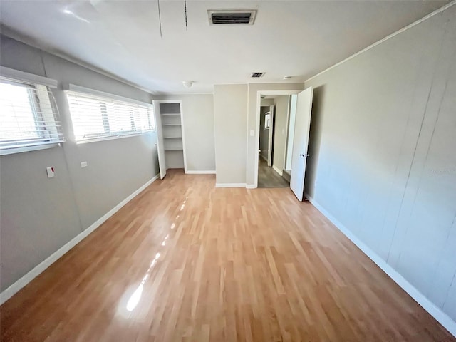 unfurnished bedroom with a closet and hardwood / wood-style floors