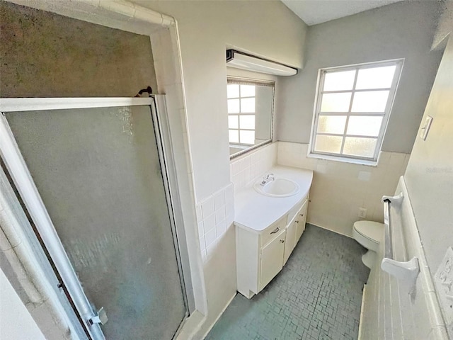 bathroom featuring vanity, toilet, and walk in shower