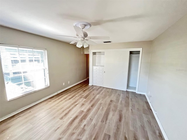 unfurnished bedroom featuring light hardwood / wood-style floors, a closet, and ceiling fan