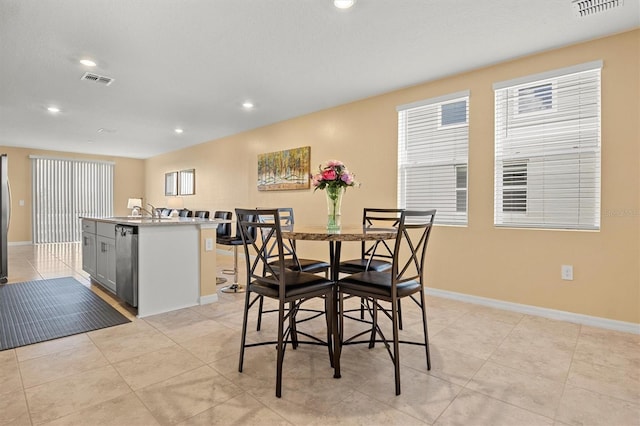 tiled dining space featuring sink