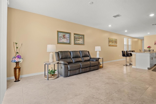 tiled living room with a textured ceiling