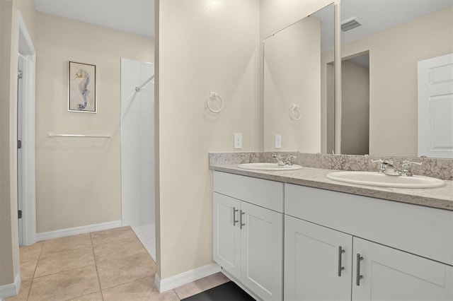 bathroom featuring vanity, tile patterned floors, and walk in shower