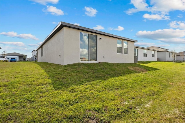 rear view of property featuring a yard