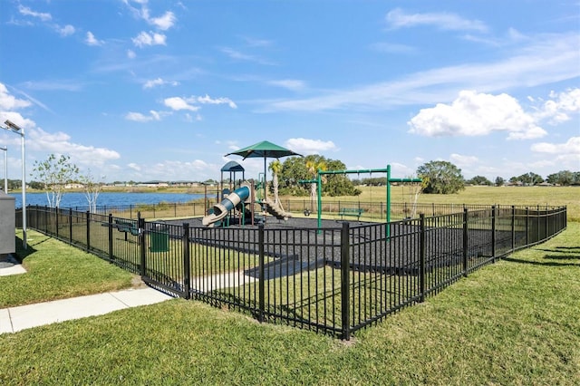 view of jungle gym with a water view and a lawn