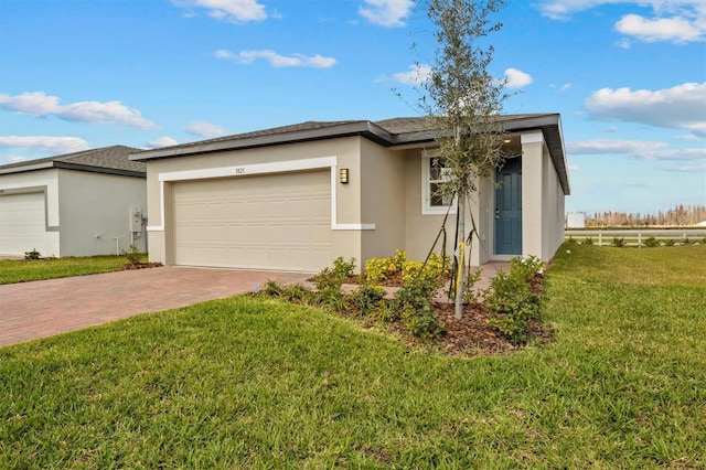 view of front of house with a garage and a front lawn