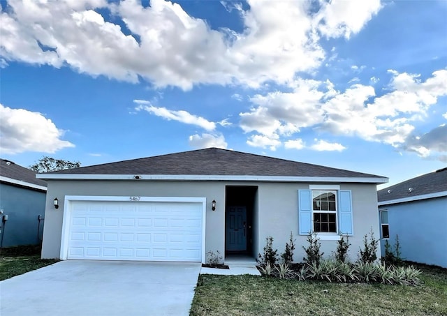 ranch-style house with an attached garage, driveway, a shingled roof, and stucco siding