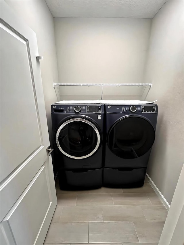 clothes washing area featuring independent washer and dryer