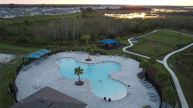 pool at dusk with a lawn