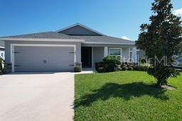 view of front of home featuring a garage and a front lawn