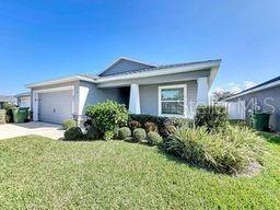 view of front of home with a garage and a front lawn