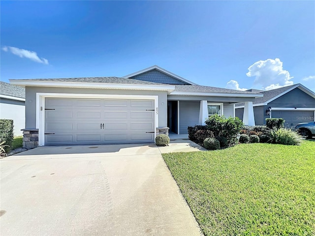 ranch-style home with stucco siding, driveway, an attached garage, and a front lawn