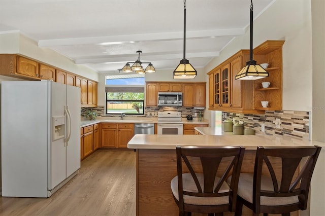 kitchen with stainless steel appliances, pendant lighting, beam ceiling, and kitchen peninsula