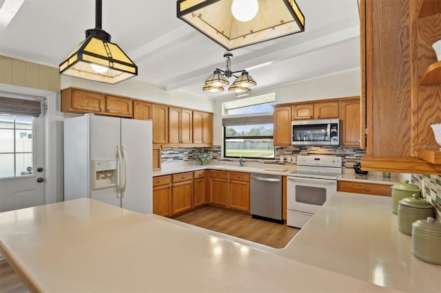 kitchen featuring tasteful backsplash, appliances with stainless steel finishes, decorative light fixtures, and beam ceiling