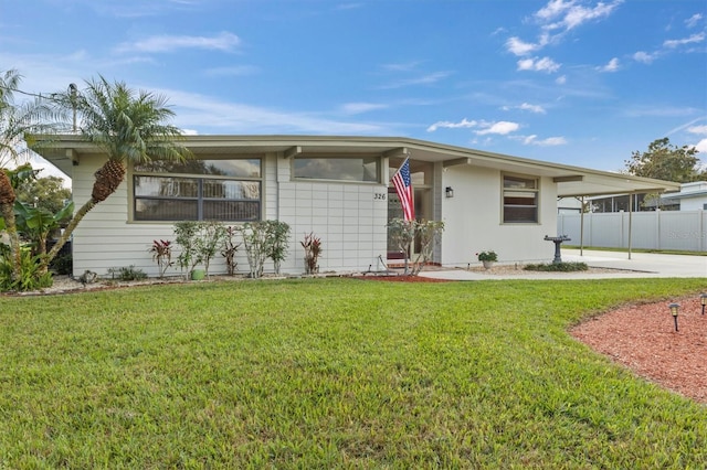 ranch-style home with a front lawn and a carport