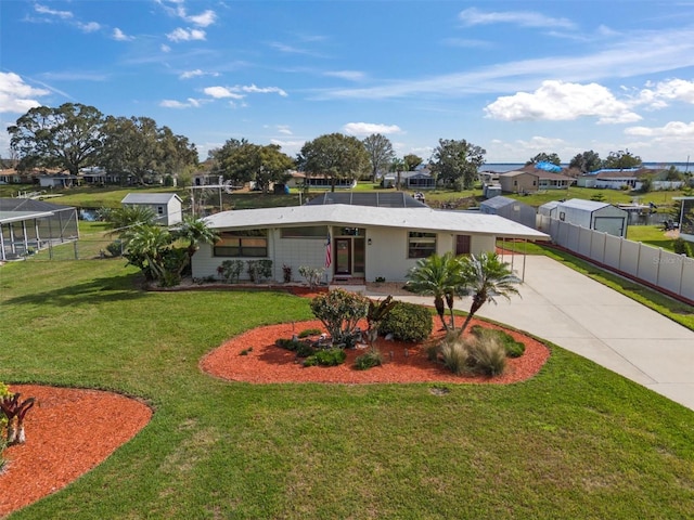 view of front of home with a front yard and a carport