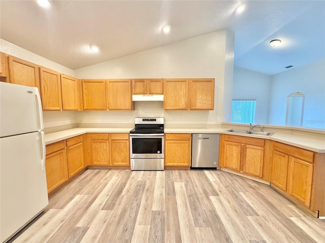 kitchen with lofted ceiling, sink, a textured ceiling, light wood-type flooring, and appliances with stainless steel finishes