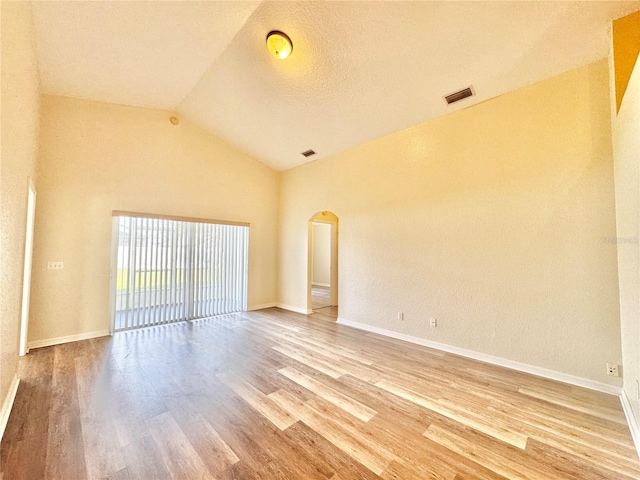 unfurnished room featuring vaulted ceiling and hardwood / wood-style floors