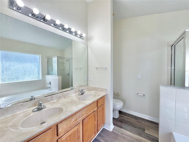 full bathroom with independent shower and bath, wood-type flooring, vanity, and toilet