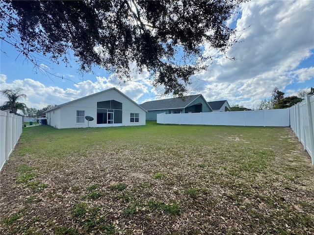 rear view of property with a lawn