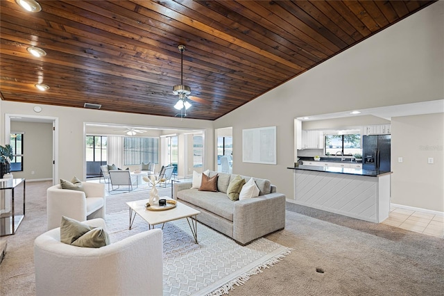 living area with light colored carpet, ceiling fan, wood ceiling, and baseboards