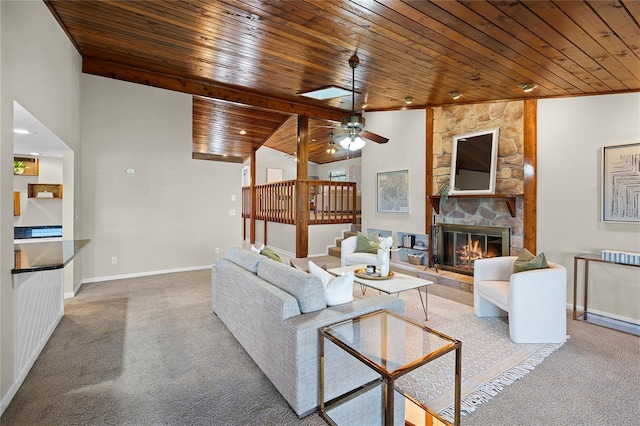 carpeted living area featuring baseboards, a fireplace, stairway, vaulted ceiling, and wood ceiling
