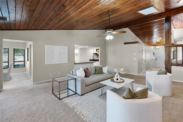 living area with baseboards, lofted ceiling, a ceiling fan, and light carpet