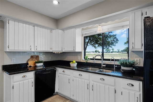 kitchen featuring white cabinets, a sink, tasteful backsplash, and black appliances