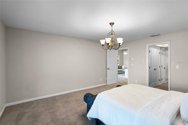carpeted bedroom featuring baseboards, visible vents, and a chandelier