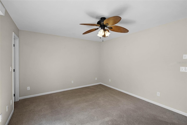 empty room featuring baseboards, carpet floors, and a ceiling fan