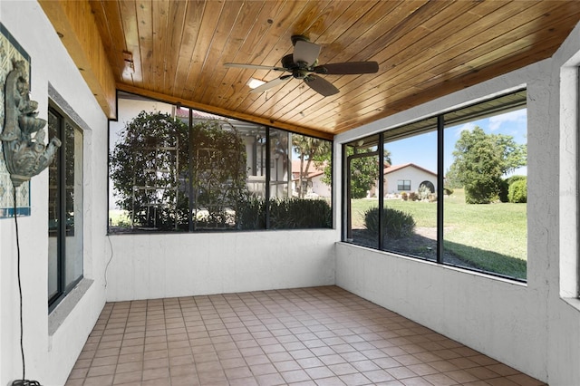 unfurnished sunroom featuring plenty of natural light and ceiling fan