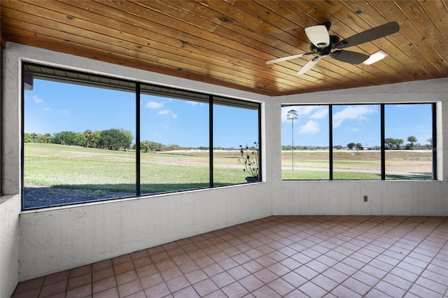 unfurnished sunroom with a ceiling fan