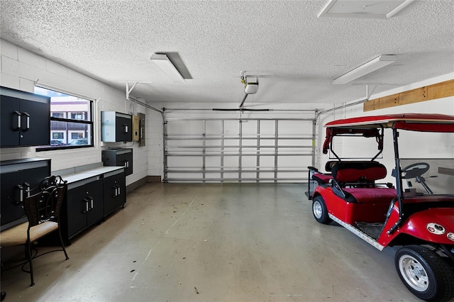 garage featuring concrete block wall and electric panel