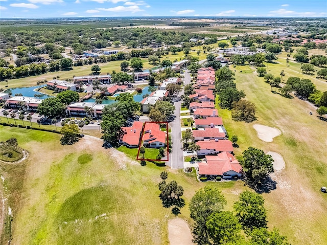 birds eye view of property with view of golf course, a residential view, and a water view