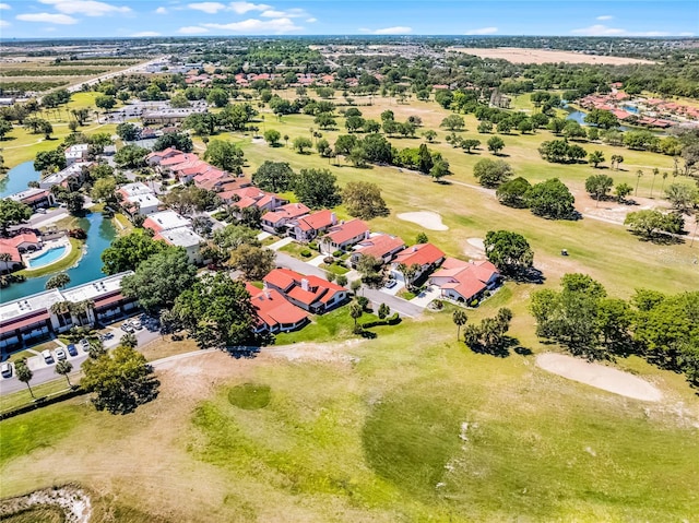 aerial view featuring a residential view, golf course view, and a water view