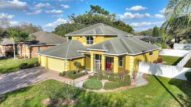 view of front of home with a garage and a front lawn