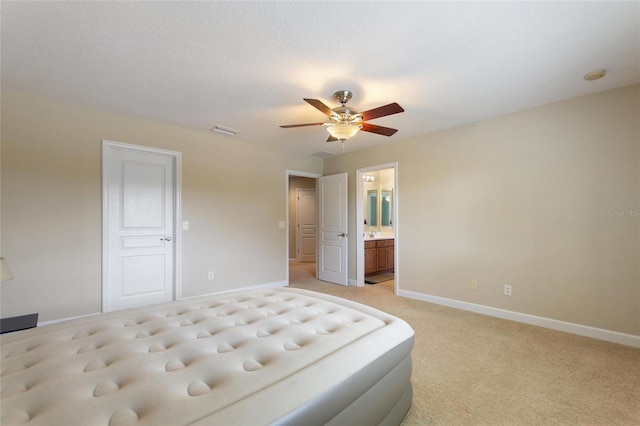 carpeted bedroom featuring connected bathroom and ceiling fan