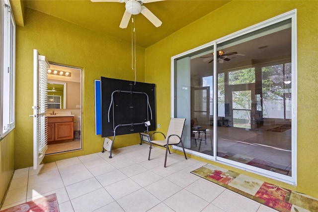 sunroom / solarium featuring sink and ceiling fan