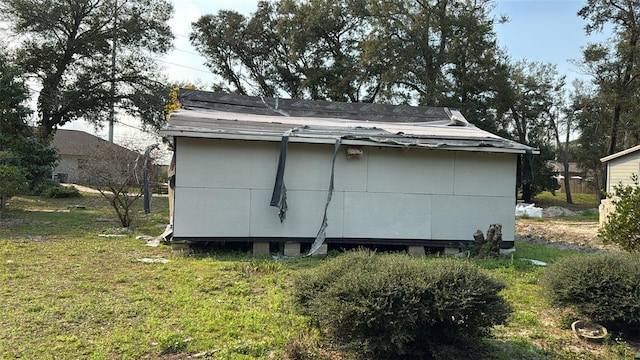 view of side of home featuring a lawn