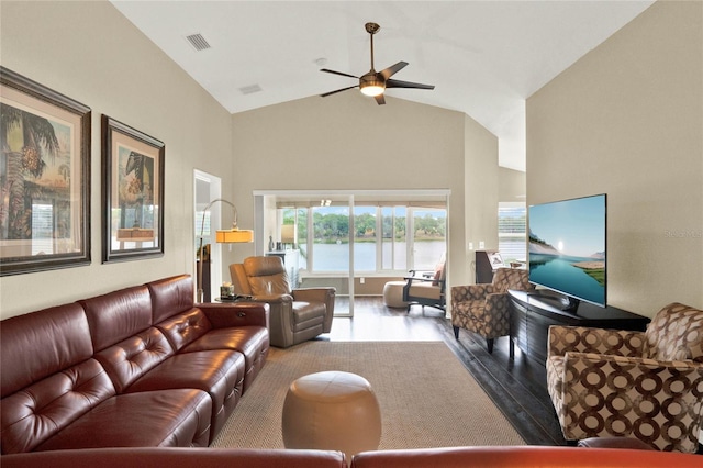 living room featuring ceiling fan, high vaulted ceiling, and light wood-type flooring