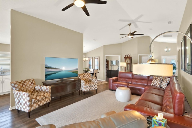 living room with high vaulted ceiling, dark hardwood / wood-style flooring, and ceiling fan with notable chandelier