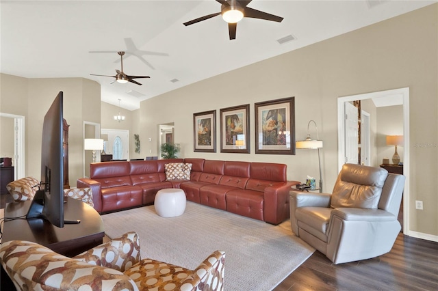 living room with ceiling fan with notable chandelier, vaulted ceiling, and dark hardwood / wood-style floors