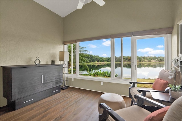 sunroom / solarium with vaulted ceiling and a water view
